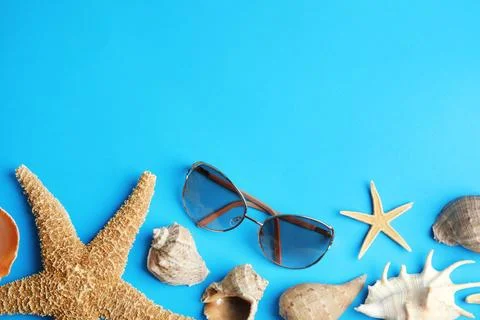 Flat lay composition with beach objects on blue background. Space for text Fotos de archivo
