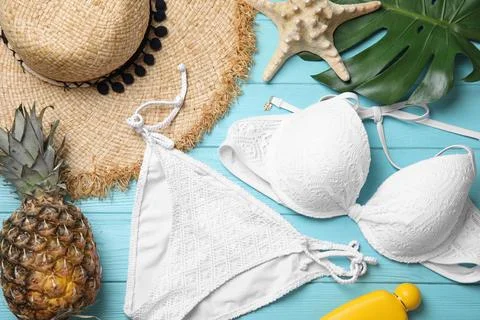 Flat lay composition with beach objects on light blue wooden background Stock Photos