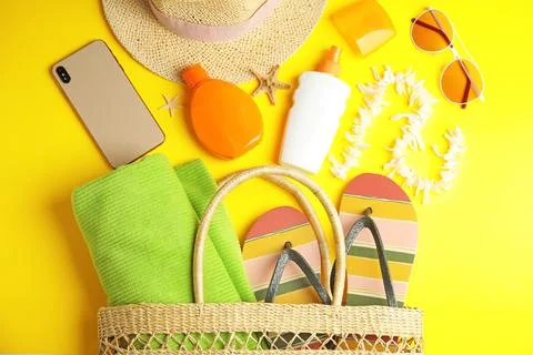 Flat lay composition with beach objects on yellow background Fotos de archivo