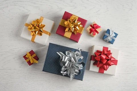 Flat lay composition with beautiful gift boxes on white wooden table Stock Photos