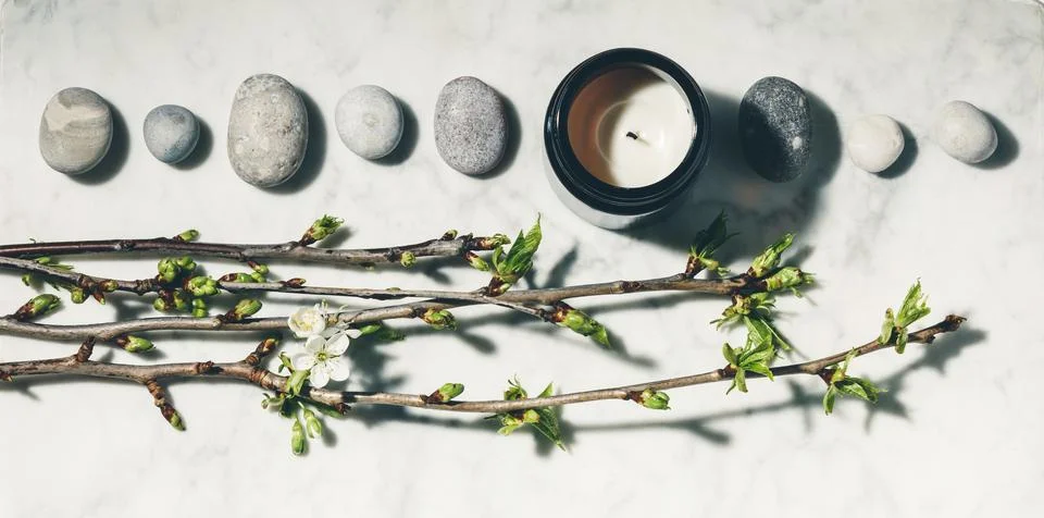Flat lay composition with beautiful spring cherry branches, natural candle .. Stock Photos