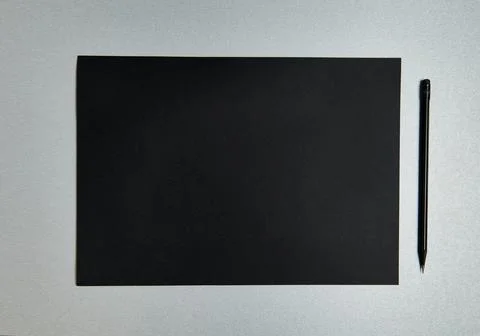 Flat lay composition of black sheet of design paper and black wooden pencil o Stock Photos