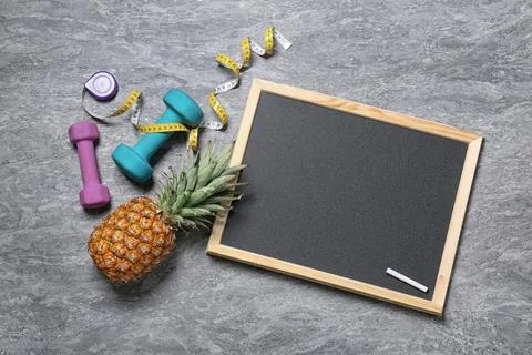 Flat lay composition with blackboard, dumbbells and space for text on gray ba 스톡 사진