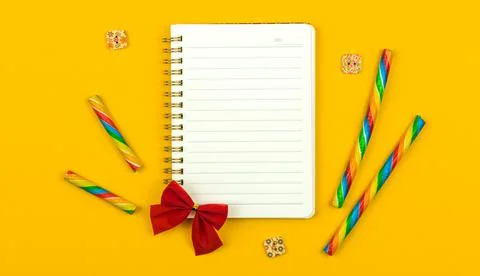 Flat lay composition with blank notebook, bright yellow background with fashi Stock Photos