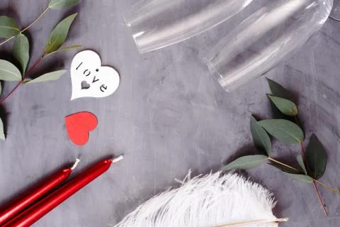 Flat lay composition with bottle of champagne, candles, feather and hearts fo Stock Photos