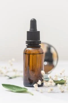Flat lay composition with bottle of natural essential oil on white marble Foto stock