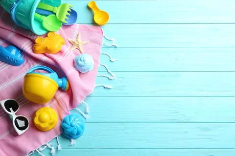 Flat lay composition with bright beach toys on color wooden background. Space 写真素材