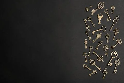 Flat lay composition with bronze vintage ornate keys on dark background, spac 스톡 사진