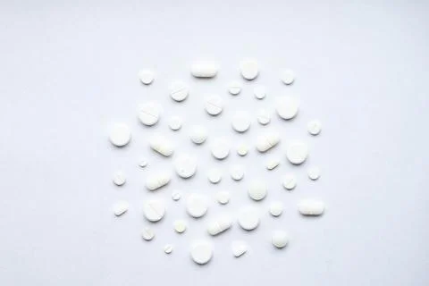 Flat lay composition with bunch of different pills scattered on table . Pile of Stock Photos