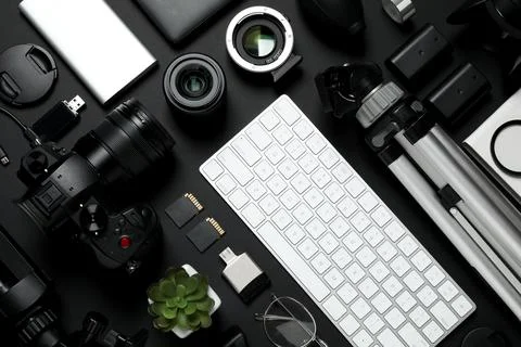 Flat lay composition with camera, video production equipment and computer key Stock Photos