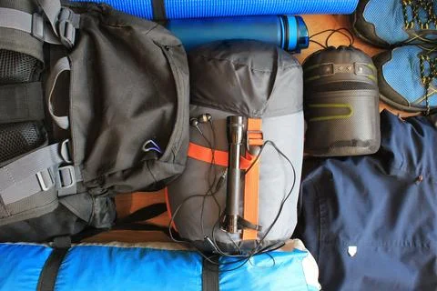 Flat lay composition with camping equipment on wooden background Stock Photos