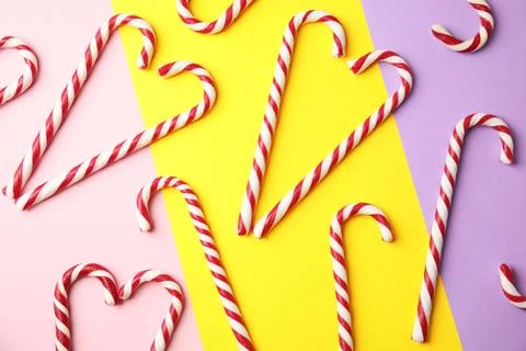 Flat lay composition with candy canes on color background Stock Photos