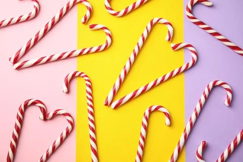 Flat lay composition with candy canes on color background Stock Photos