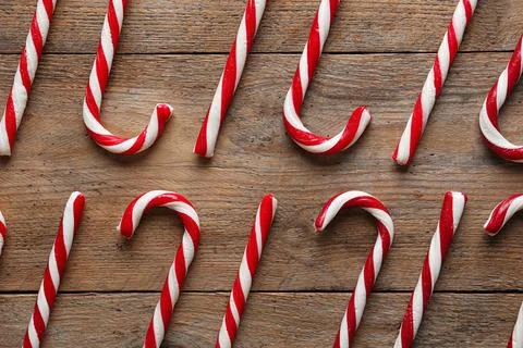 Flat lay composition with candy canes on wooden background. Traditional Chris Stock Photos