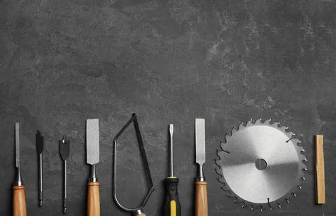 Flat lay composition with carpenter's tools on grey background. Space for tex Stock Photos