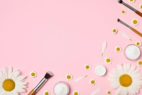 Flat lay composition with chamomiles, beauty accessories and cosmetic product Stock Photos