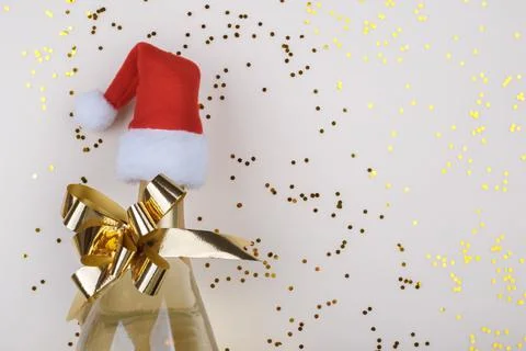 Flat lay composition of Champagne bottle and confetti on beige background cop Stock Photos