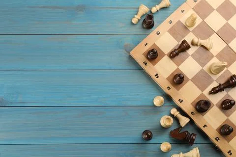 Flat lay composition of chess on light blue wooden table, space for text. Boa 写真素材