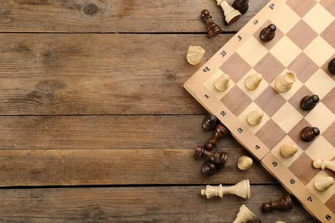 Flat lay composition of chess on wooden table, space for text. Board game Stockfoto's