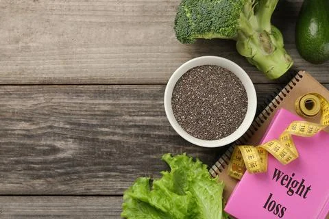 Flat lay composition with chia seeds, notebooks and measuring tape on woode.. Stock Photos