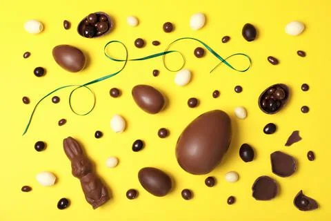 Flat lay composition with chocolate Easter eggs on color background Stock Photos