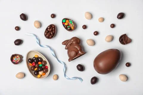 Flat lay composition with chocolate Easter eggs on white background Stock Photos