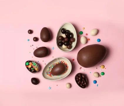 Flat lay composition with chocolate Easter eggs on color background Stock Photos