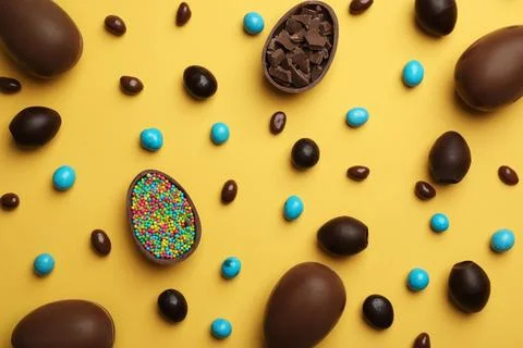 Flat lay composition with chocolate Easter eggs on color background Stock Photos
