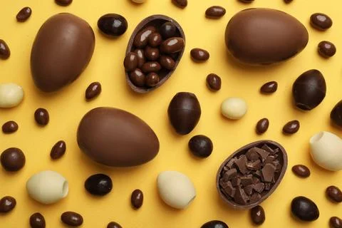 Flat lay composition with chocolate Easter eggs on color background Stock Photos