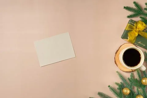 Flat lay composition with Christmas decor and blank card on beige background. Stock Photos