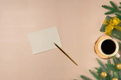 Flat lay composition with Christmas decor and blank card on beige background. Stock Photos