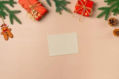Flat lay composition with Christmas decor and blank card on beige background. Stock Photos