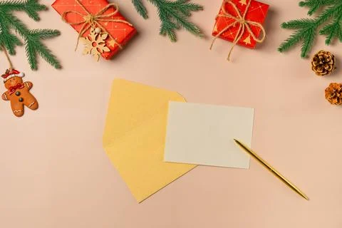 Flat lay composition with Christmas decor and blank card on beige background. Stock Photos
