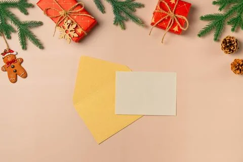 Flat lay composition with Christmas decor and blank card on beige background. Stock Photos
