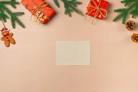 Flat lay composition with Christmas decor and blank card on beige background. Stock Photos