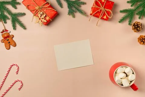 Flat lay composition with Christmas decor and blank card on beige background. Stock Photos