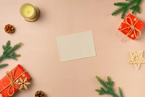 Flat lay composition with Christmas decor and blank card on beige background. Stock Photos
