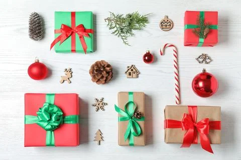 Flat lay composition with Christmas gift boxes on white wooden background Stock Photos