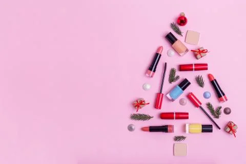Flat lay composition christmas tree with lipsticks and Christmas decor. Stock Photos