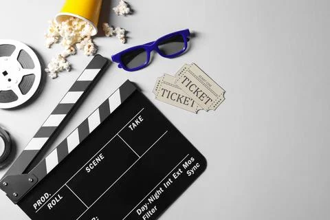 Flat lay composition with clapperboard, film reel and 3D glasses on grey ba.. Stock Photos