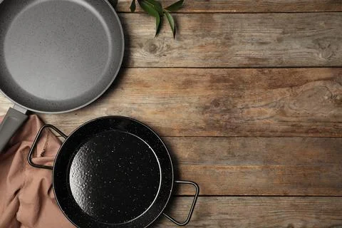Flat lay composition with clean cookware and space for text on wooden backgro Stock Photos