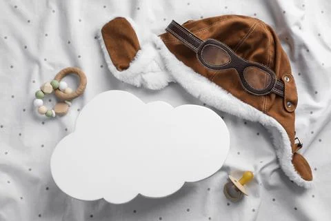 Flat lay composition with cloud shaped child's night lamp on white fabric Stock Photos