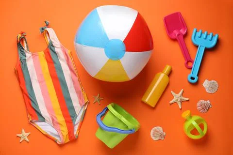 Flat lay composition with colorful beach ball and sand toys on orange backgro 写真素材
