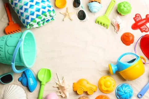 Flat lay composition with colorful beach toys on sand. Space for text 写真素材