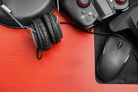 Flat lay composition with computer mouse and gaming gear on table Stock Photos