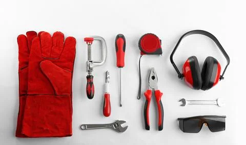 Flat lay composition with construction tools and safety equipment on white ba Stock Photos