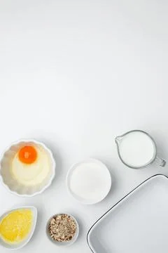 Flat lay composition for cooking preparation. Empty white baking dish with in Stock Photos