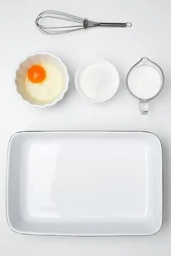 Flat lay composition for cooking preparation. Empty white baking dish with in Stock Photos