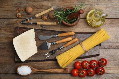 Flat lay composition with cooking utensils and fresh ingredients on wooden ta Stock Photos