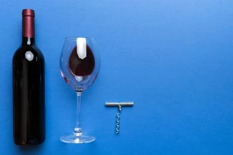 Flat lay composition with corkscrew, bottle of wine and elegant glass on co.. Stock Photos